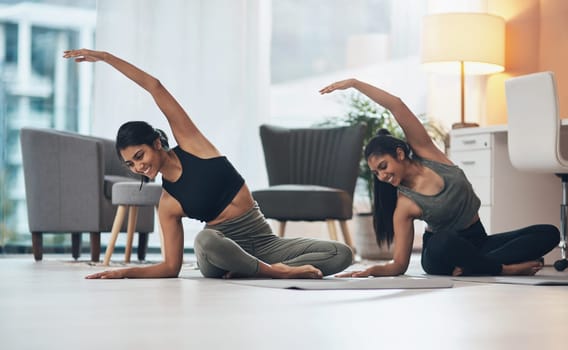 Women, yoga exercise and friends together in a house with happiness, health and wellness. Indian sisters or female family on lounge floor for stretching workout, balance and fitness with partner.