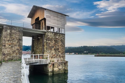 View of the Bay of San Esteban de Pravia in Asturias with an old coal loading port in the foreground.