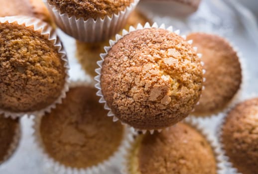 Overhead view of a group of freshly baked cupcakes with shallow depth of field.