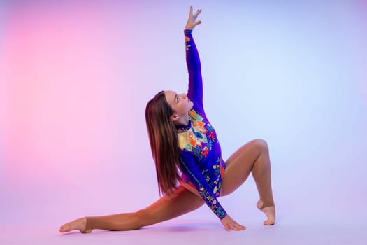 Full length teen girl smiling doing fitness exercises, isolated on a white and dark background