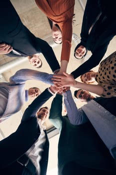 A group of businessmen holding hands together to symbolize unity and strength.