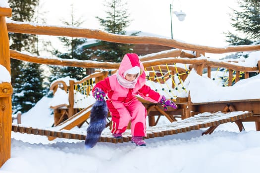 little girl outdoors in winter day.