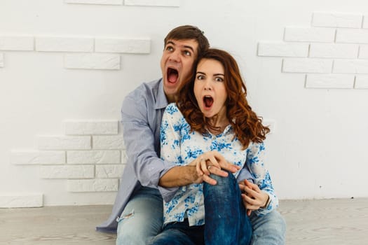 Image of a positive shocked young loving couple isolated over background