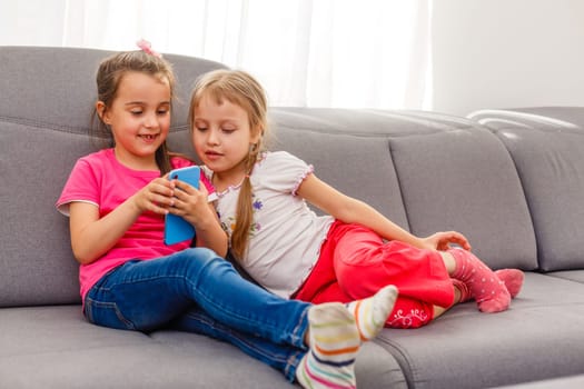 Two adorable little sisters taking photo of themself.