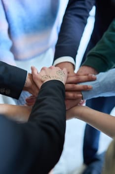 A top view photo of group of businessmen holding hands together to symbolize unity and strength. High quality photo