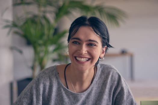 In a modern office, a young smile businesswoman with glasses confidently explains and presents various business ideas to her colleagues, showcasing her professionalism and expertise