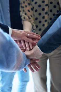 A top view photo of group of businessmen holding hands together to symbolize unity and strength. High quality photo