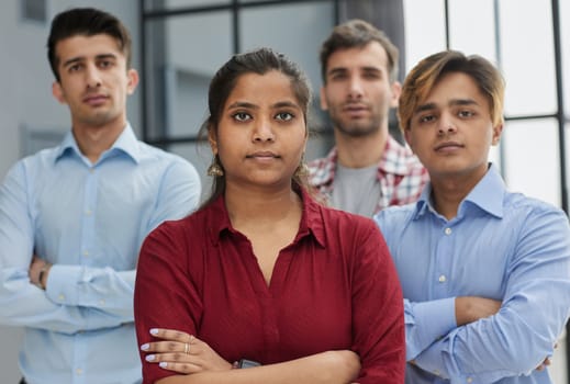 Theyre all about their business. Shot of a group of businesspeople standing in an office at work.