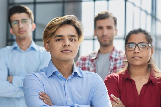 Were the ones who make things happen. Shot of a diverse group of businesspeople standing together in the office with their arms folded.