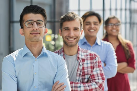 Everybody brings a different skill to the team. Portrait of a diverse group of coworkers standing in an office.