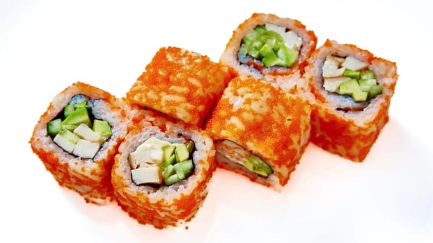 California Maki Sushi with Masago. Roll made of Crab Meat, Avocado, Cucumber inside. Masago outside. Shallow dof