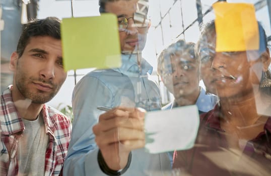 Group of business people behind glass wall at office