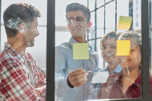 Group of business people behind glass wall at office