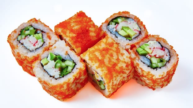 California Maki Sushi with Masago. Roll made of Crab Meat, Avocado, Cucumber inside. Masago outside. Shallow dof