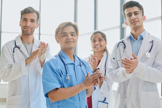 Smiling doctor with fellow doctors standing in the background