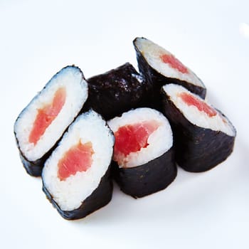 Traditional Japanese maki rolls with tuna on a white background