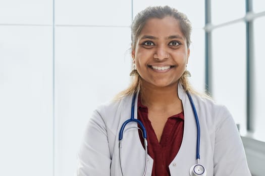 doctor stands in the hospital corridor and looks at the camera