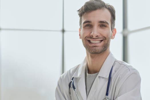 man smiling and looking at camera, doctor student intern with stethoscope