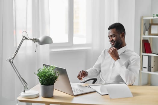 home man employee african student american office online smiling education job laptop freelancer black space communication copy african blank space computer looking freelance cyberspace