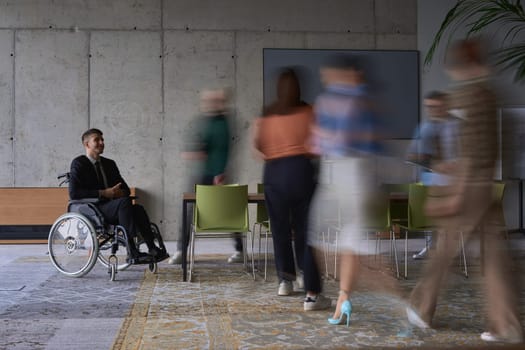A businessman in a wheelchair in a modern office, surrounded by his colleagues who are portrayed with blurred movements, symbolizing their support and solidarity as they navigate the workspace together