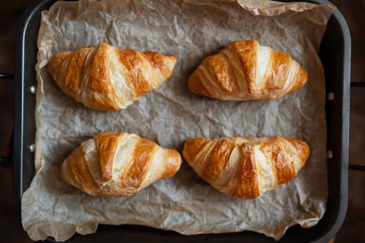 The croissants on the tray are fresh from the oven, crispy and fresh. Morning pastries, dessert for coffee