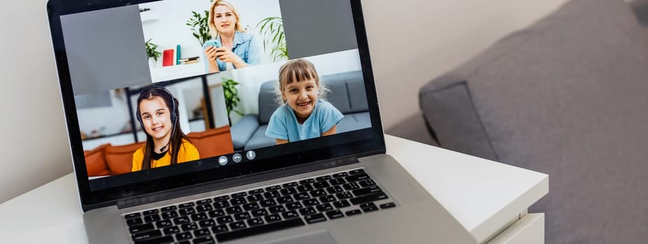 A Girl Video Conferencing With Happy Female Teacher On Laptop.