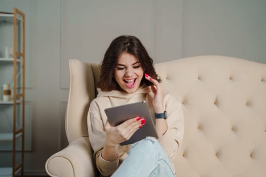 Shocked young woman looking at tablet computer screen, unexpected news, emotional client.