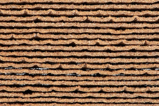 Texture of rye chips. Chips are stacked, one on top of the other, close-up side view