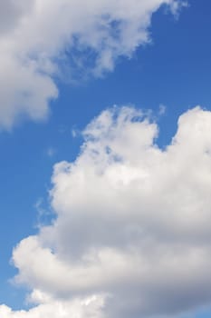 Clouds in bright blue sky nature background or texture