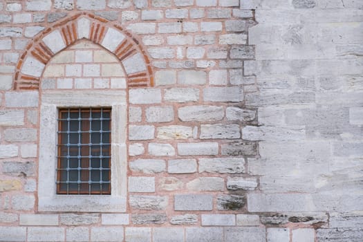 Window on a brick wall under brick arch