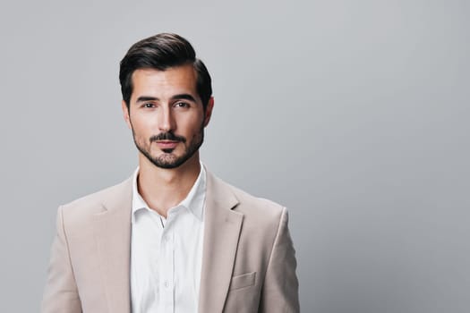 suit man portrait arm smiling young success corporate businessman entrepreneur beige business handsome happy professional stylish posing isolated copyspace office guy