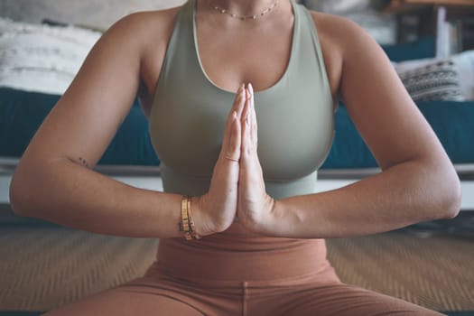 Yoga is known for its ability to soothe tension and anxiety. Closeup shot of a woman meditating while practising yoga at home