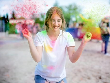 Pretty girls in indian traditional Holi festival with colorful powder having fun. Female teenager and preteen child enjoying positive holiday of India