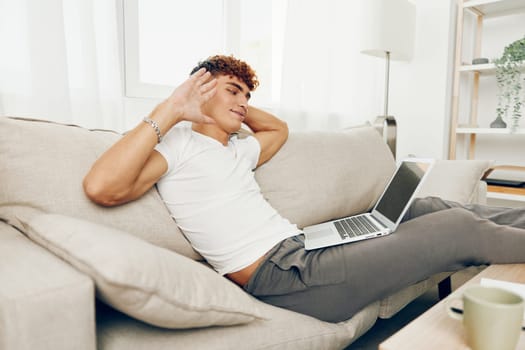 man interior curly freelance internet typing blissful job laptop business phone online communication browsing education