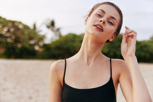 smiling woman ocean sand freedom nature beach lifestyle walking sea carefree smile sunset holiday young summer water vacation enjoyment copy-space leisure