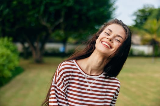 woman meditation walk active lifestyle carefree summer freedom t-shirt park striped smiling person grass joy walking beautiful smile hat bag nature