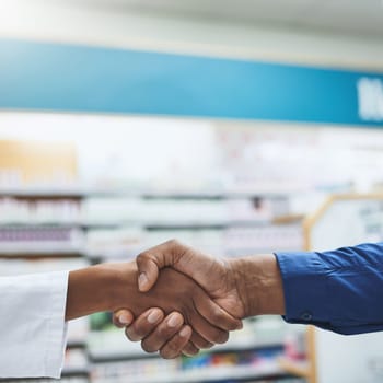 Its a life changing relationship. a pharmacist and a customer shaking hands