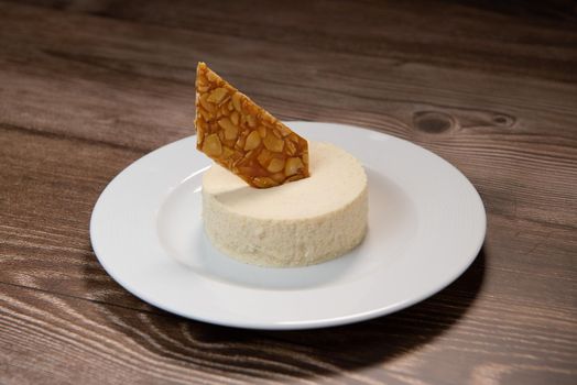 Bavarian recipe with pear and vanilla served with almond nougatine. High quality photo
