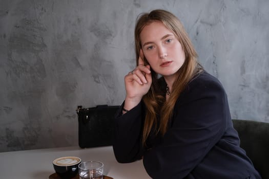 charming confident brunette woman in a cafe with coffee. coffee break. business woman.