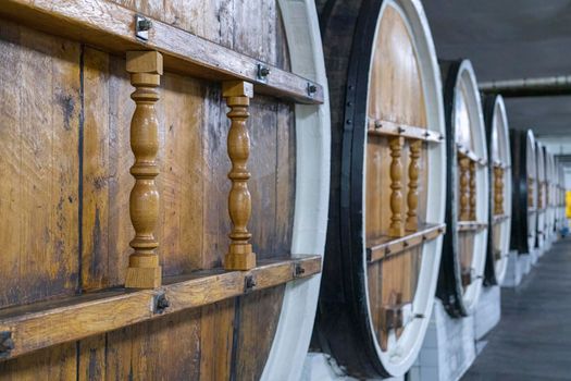 barrels of wine in wine cellars close-up. High quality photo