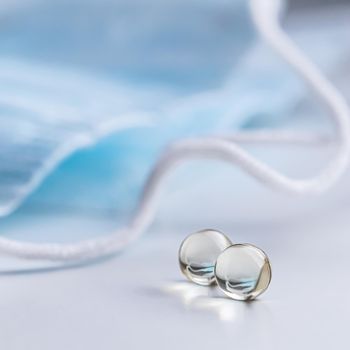 Capsules, pills and medical masks on a white background. Health care, medical, pharmacy and illness concept