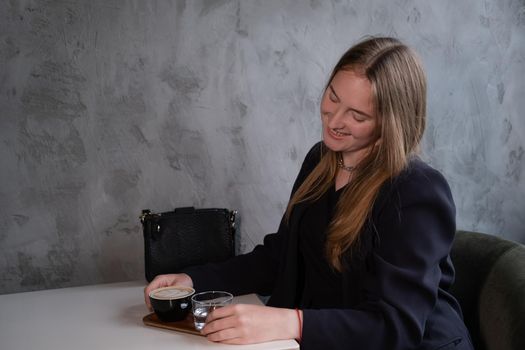 charming confident brunette woman in a cafe with coffee. coffee break. business woman.