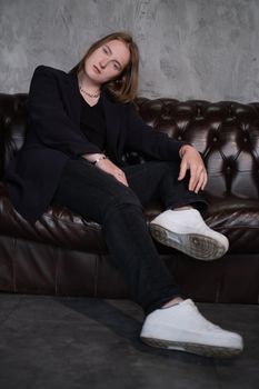 portrait of confident woman in black in dark room. pensive serious people. business woman. feminine. millennial people.