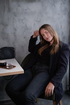 charming confident brunette woman in a cafe with coffee. coffee break. business woman.