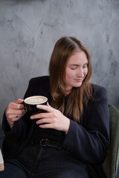 charming confident brunette woman in a cafe with coffee. coffee break. business woman.