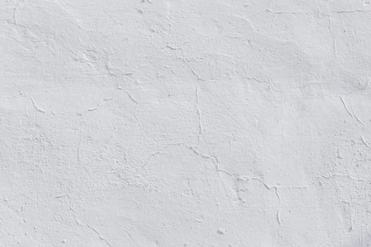 shabby dry white plaster under direct sunlight texture and full frame background