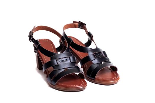 Women's black sandals with straps isolated on a white background close up