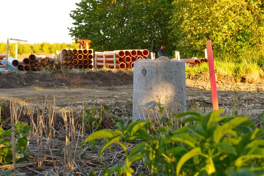 sewer orange pvc pipes stacked on construction site. plumbing plastic pipes.