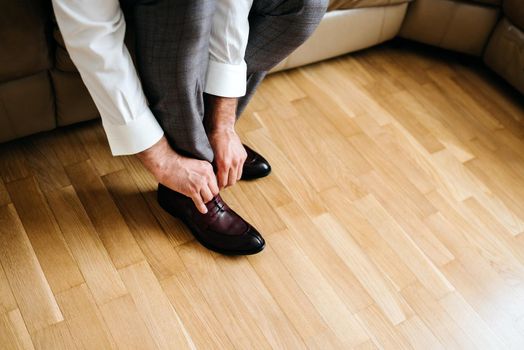 businessman putting on shoes, man getting ready for work