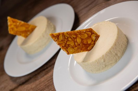 Bavarian recipe with pear and vanilla served with almond nougatine. High quality photo